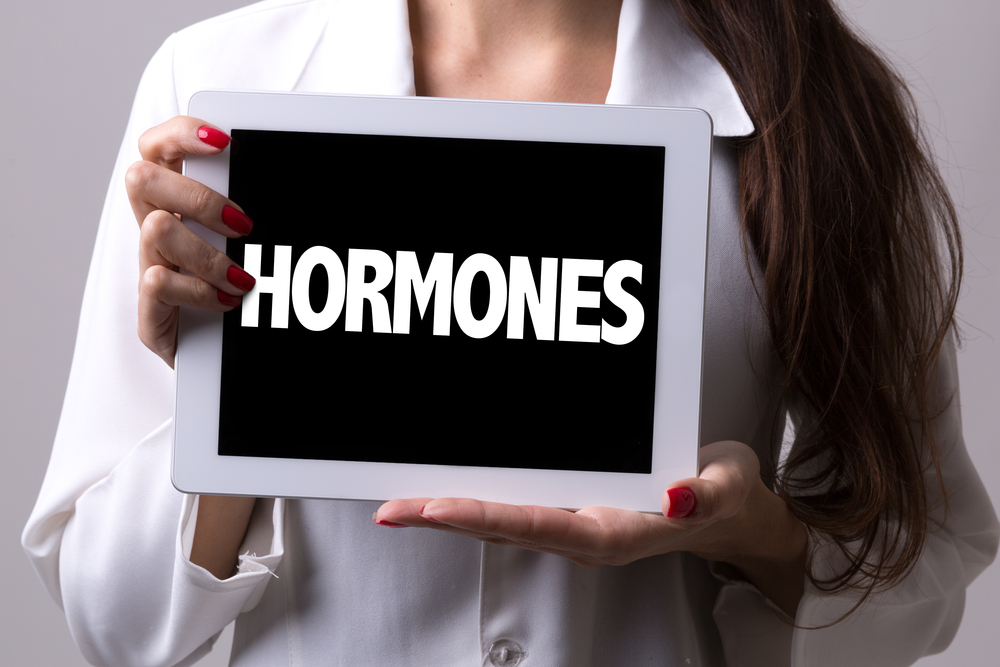 Female,Doctor,Holding,A,Tablet,With,The,Text:,Hormones